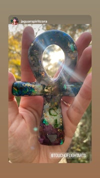 a person holding an opal nebula in their hand