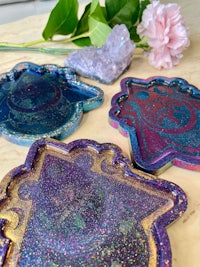 four hamsa shaped plates on a table