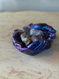 a blue and purple bowl with crystals in it