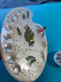 a person holding a plate with a lot of plants on it