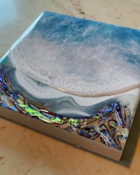 a glass coaster with an ocean scene on it