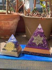 two pyramids sitting on top of a blue box