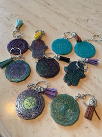 hamsa keychains with tassels on a table