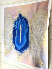 a painting of an angel with wings hanging on a wall