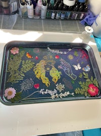 a tray with flowers and butterflies on it