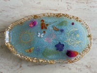 a blue plate with flowers and butterflies on it