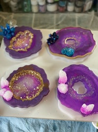 a group of purple and gold agates on a tray