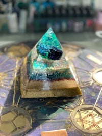 a blue and green pyramid on top of a table