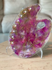 a purple and gold palette on a table