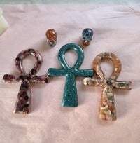 three egyptian ankhs and a ring