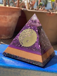 a purple pyramid sitting on top of a blue table