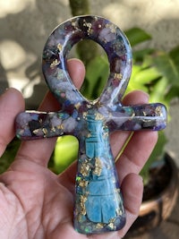 a person holding an ankh in their hand