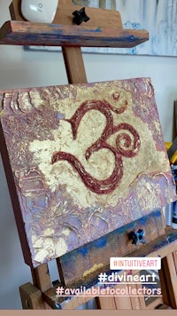 an easel with an om painted on it