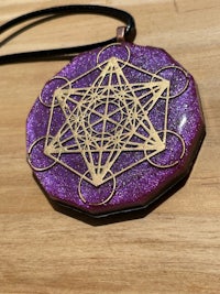 a purple and gold necklace with a geometric design on it
