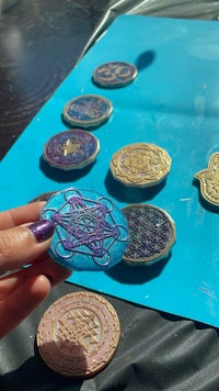 a person is holding a set of coins on a table