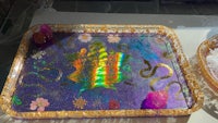a tray with a purple and gold design on it